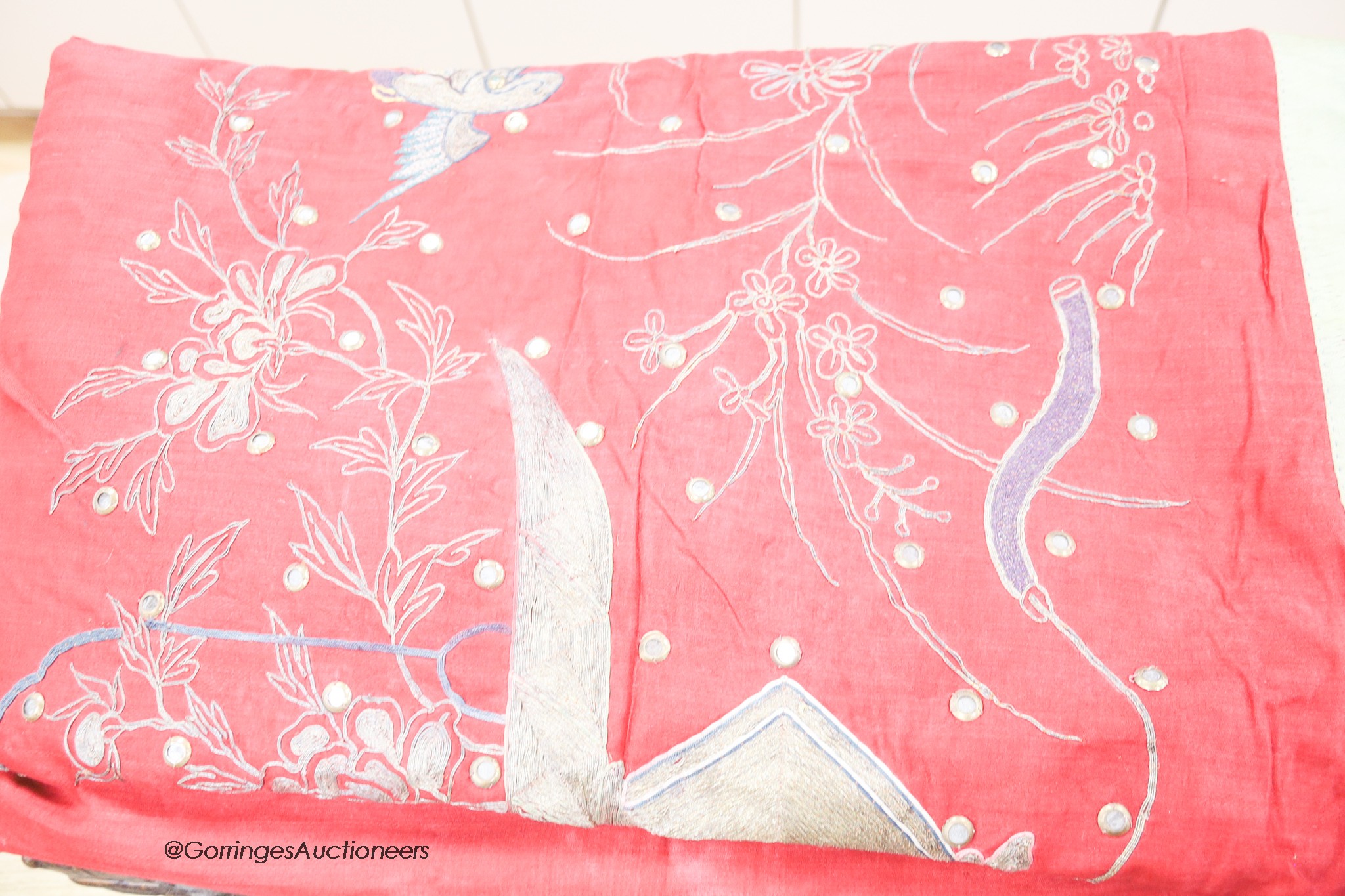 Two Chinese red silk hangings, a mauve damask hanging and a brightly coloured silk panel